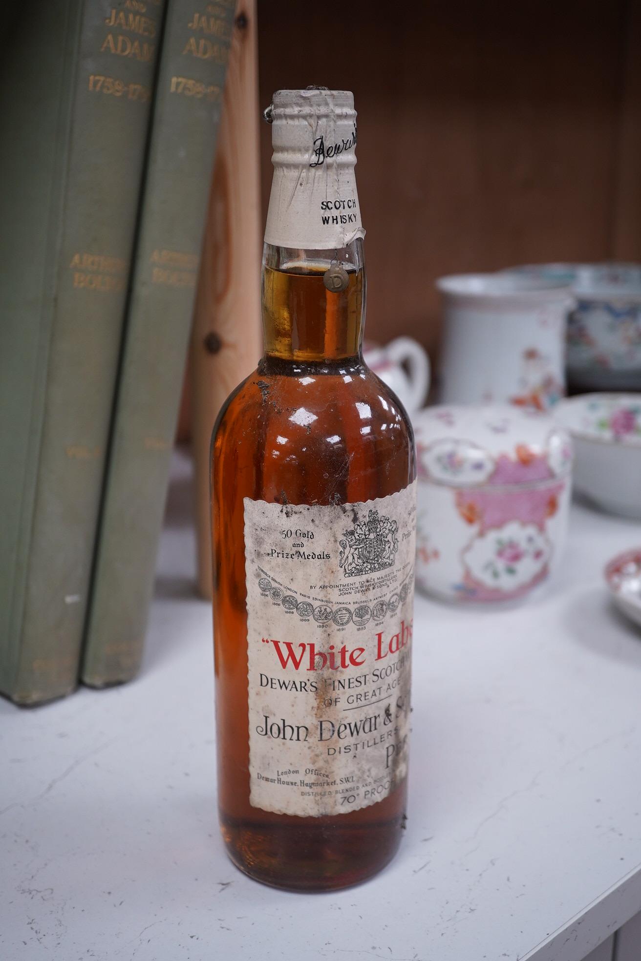 John Dewar & Sons Ltd. White Label, Finest Scotch Whisky Of Great Age, By Appointment to Her Majesty The Queen. Condition - label stained, bottle dirty, sealed